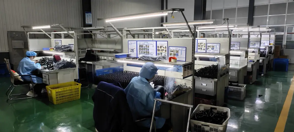 SRRP operators inspecting and assembling components at illuminated workstations